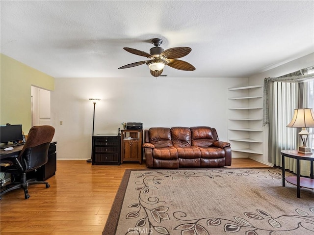 14719 Juniper St, Hesperia, CA 92345 - living area with light wood finished floors, an office area, a ceiling fan, and a textured ceiling
