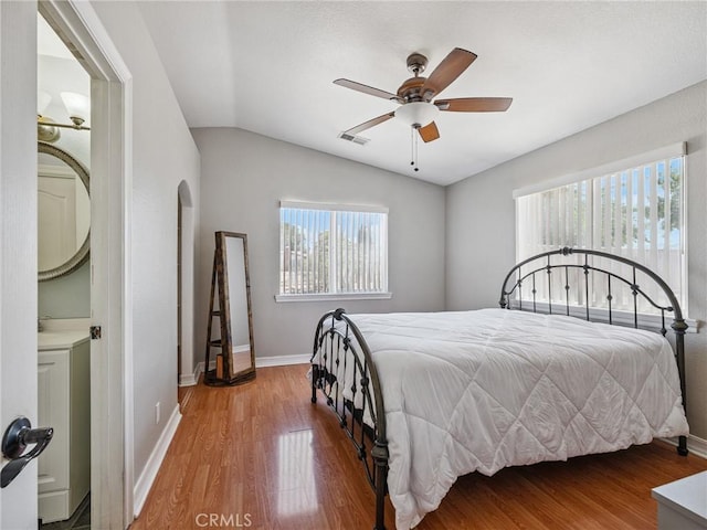 14719 Juniper St, Hesperia, CA 92345 - bedroom featuring lofted ceiling, wood finished floors, arched walkways, and a ceiling fan