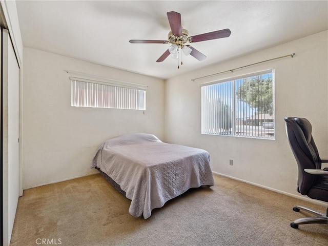 14719 Juniper St, Hesperia, CA 92345 - carpeted bedroom with a desk and a ceiling fan