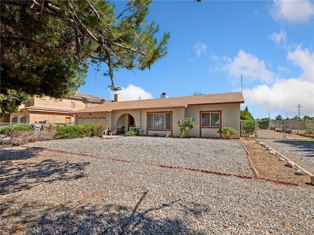 14719 Juniper St, Hesperia, CA 92345 - ranch-style house with an attached garage, stucco siding, a chimney, and driveway