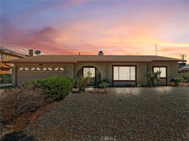 14719 Juniper St, Hesperia, CA 92345 - ranch-style house featuring a garage, stucco siding, and a chimney