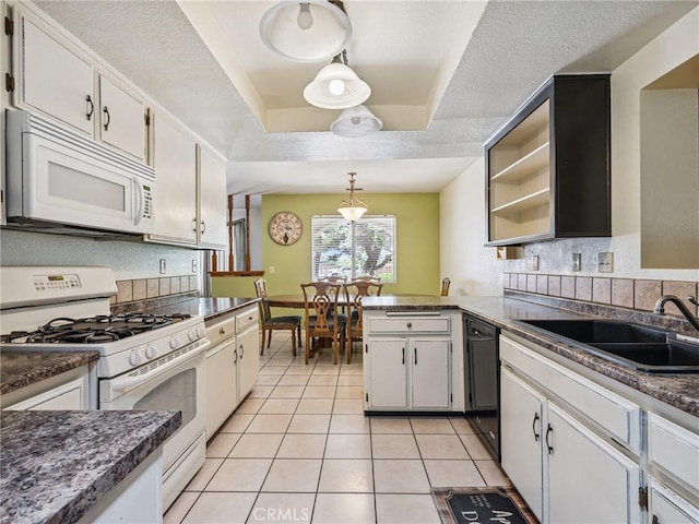 14719 Juniper St, Hesperia, CA 92345 - kitchen with white appliances, light tile patterned floors, a tray ceiling, and decorative backsplash