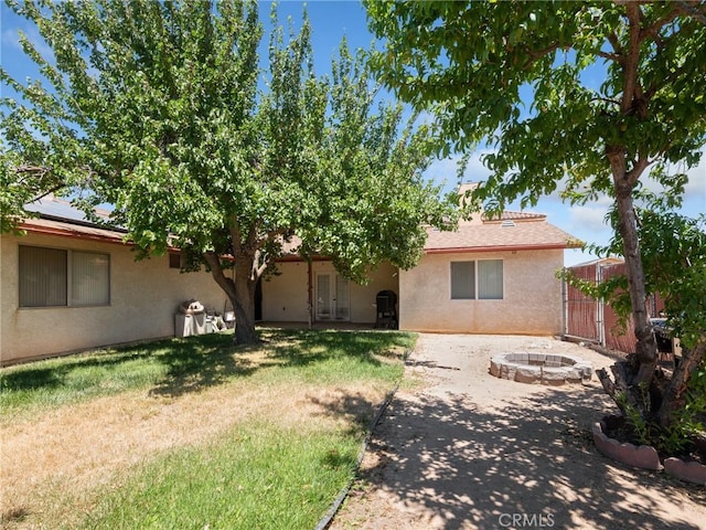 14719 Juniper St, Hesperia, CA 92345 - view of front of home featuring stucco siding, an outdoor fire pit, a gate, and a patio area