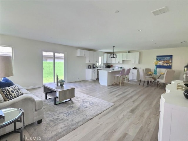 378 W Rosa Parks Rd, Palm Springs, CA 92262 - living room featuring light wood-type flooring and baseboards