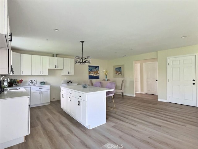 378 W Rosa Parks Rd, Palm Springs, CA 92262 - kitchen with a kitchen island, light wood-type flooring, white cabinets, and recessed lighting