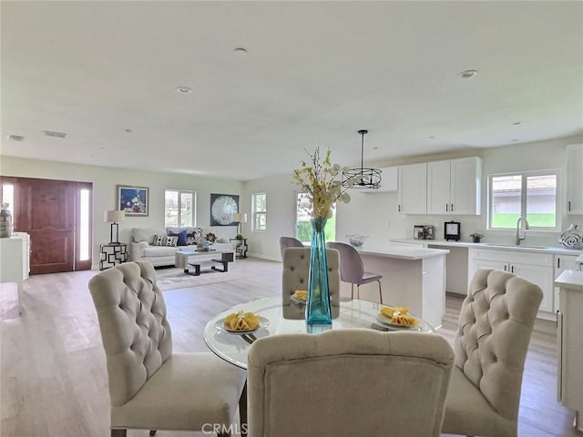 378 W Rosa Parks Rd, Palm Springs, CA 92262 - living room featuring plenty of natural light, light wood finished floors, a chandelier, and recessed lighting