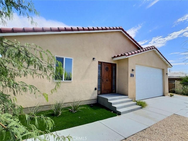 378 W Rosa Parks Rd, Palm Springs, CA 92262 - mediterranean / spanish home with stucco siding, driveway, a garage, and a tile roof