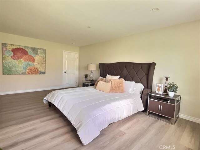 378 W Rosa Parks Rd, Palm Springs, CA 92262 - bedroom with wood finished floors and baseboards
