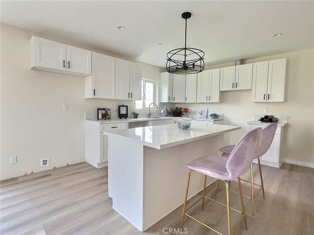 378 W Rosa Parks Rd, Palm Springs, CA 92262 - kitchen with a kitchen island, white cabinetry, light wood finished floors, and recessed lighting