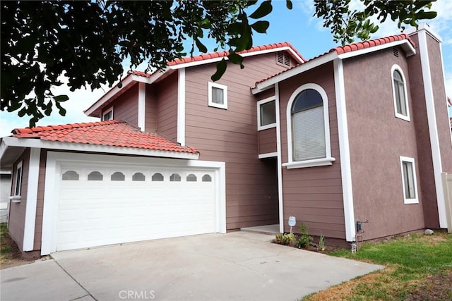 1387 Sycamore Ln, San Bernardino, CA 92408 - view of front facade featuring concrete driveway, a tile roof, and a garage