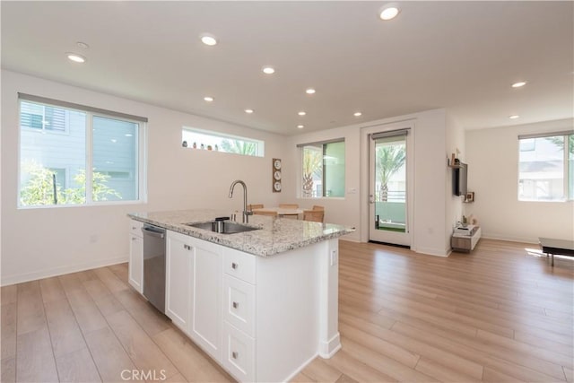 1851 S Union St Unit 10, Anaheim, CA 92805 - kitchen with stainless steel dishwasher, light wood-type flooring, an island with sink, white cabinetry, and recessed lighting