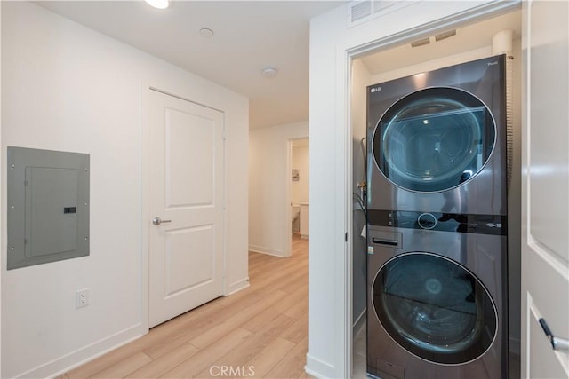 1851 S Union St Unit 10, Anaheim, CA 92805 - laundry room featuring electric panel, stacked washer / dryer, and wood finished floors