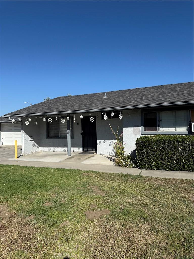 15165 Joy St, Lake Elsinore, CA 92530 - ranch-style home featuring stucco siding, a front lawn, and a garage