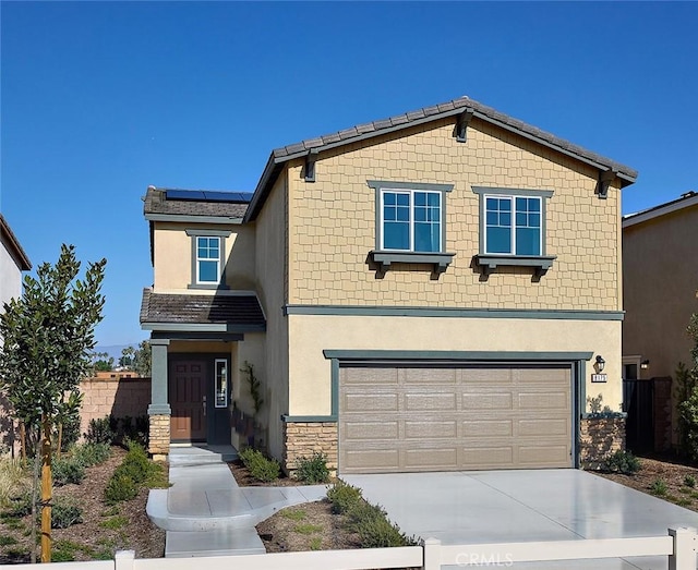 8176 Perada St, Jurupa Valley, CA 92509 - view of front of house with an attached garage, roof mounted solar panels, stucco siding, and concrete driveway