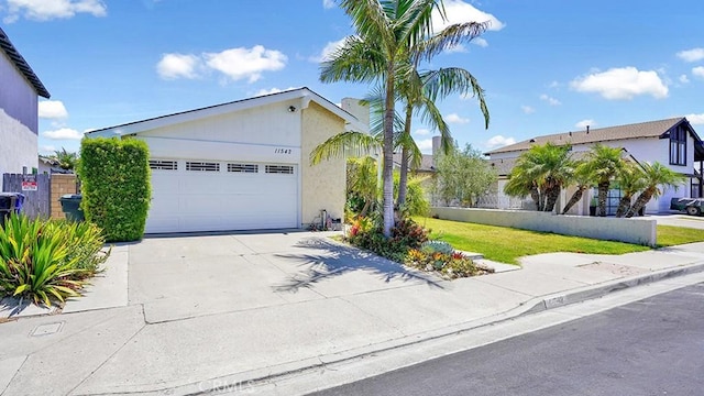 11542 Luzon St, Cypress, CA 90630 - view of front of property featuring driveway, an attached garage, and stucco siding