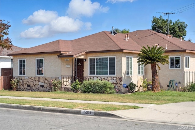 12218 Academy Way, Artesia, CA 90701 - bungalow-style house with stucco siding, stone siding, and a front yard