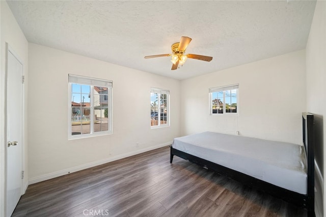 12218 Academy Way, Artesia, CA 90701 - bedroom featuring wood finished floors, a textured ceiling, and a ceiling fan
