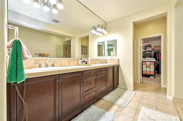 18977 Phelham Way, Yorba Linda, CA 92886 - bathroom featuring double vanity, tile patterned floors, a walk in closet, a chandelier, and tiled shower