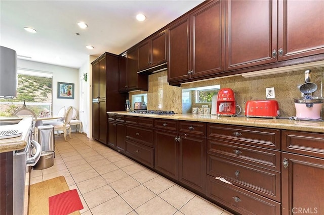 18977 Phelham Way, Yorba Linda, CA 92886 - kitchen with light tile patterned flooring, decorative backsplash, stainless steel gas stovetop, recessed lighting, and light stone counters