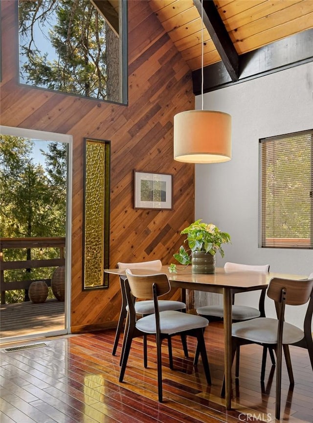 28645 Shenandoah Dr, Lake Arrowhead, CA 92352 - dining room with wood walls, hardwood / wood-style flooring, a towering ceiling, and a wood ceiling with exposed beams