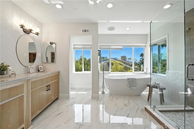 24901 Del Monte St, Laguna Hills, CA 92653 - bathroom featuring healthy amount of natural light, vanity, marble tiled floors, a freestanding tub, and recessed lighting