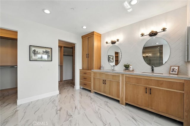 24901 Del Monte St, Laguna Hills, CA 92653 - bathroom featuring double vanity, marble finish flooring, recessed lighting, and decorative backsplash