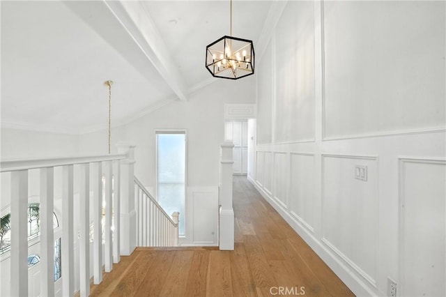 24901 Del Monte St, Laguna Hills, CA 92653 - corridor with an upstairs landing, a chandelier, a decorative wall, wood finished floors, and wainscoting