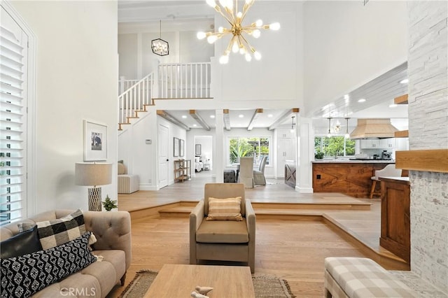 24901 Del Monte St, Laguna Hills, CA 92653 - living room with light wood-type flooring, a high ceiling, a chandelier, and stairs