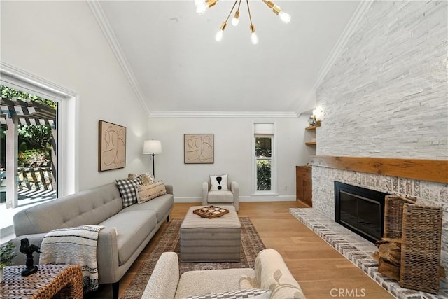 24901 Del Monte St, Laguna Hills, CA 92653 - living area with a chandelier, lofted ceiling, ornamental molding, wood finished floors, and a large fireplace