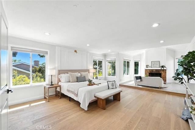 24901 Del Monte St, Laguna Hills, CA 92653 - bedroom with ornamental molding, light wood-type flooring, recessed lighting, and a brick fireplace