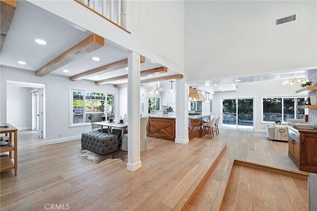 24901 Del Monte St, Laguna Hills, CA 92653 - living room featuring light wood-type flooring, a towering ceiling, recessed lighting, and beam ceiling