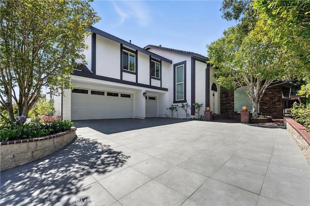 24901 Del Monte St, Laguna Hills, CA 92653 - view of front of property featuring a garage, driveway, and stucco siding