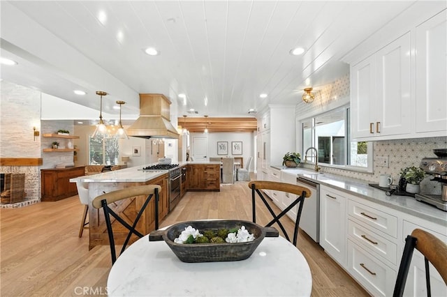 24901 Del Monte St, Laguna Hills, CA 92653 - kitchen with premium range hood, light wood-style flooring, dishwasher, white cabinets, and recessed lighting