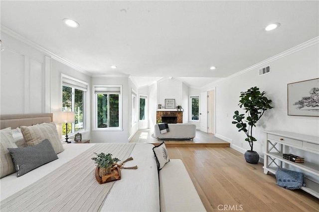 24901 Del Monte St, Laguna Hills, CA 92653 - bedroom featuring light wood-style flooring, recessed lighting, a fireplace, and ornamental molding