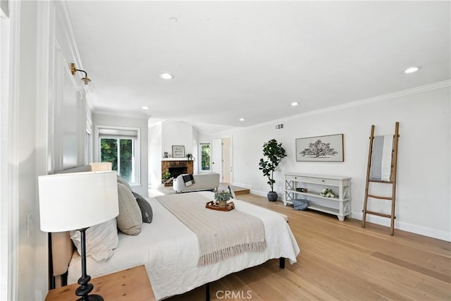 24901 Del Monte St, Laguna Hills, CA 92653 - bedroom featuring crown molding, recessed lighting, light wood-style flooring, and a fireplace