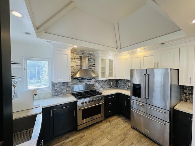 3943 Ingraham St, San Diego, CA 92109 - kitchen with wall chimney exhaust hood, high end appliances, dark cabinets, vaulted ceiling, and recessed lighting