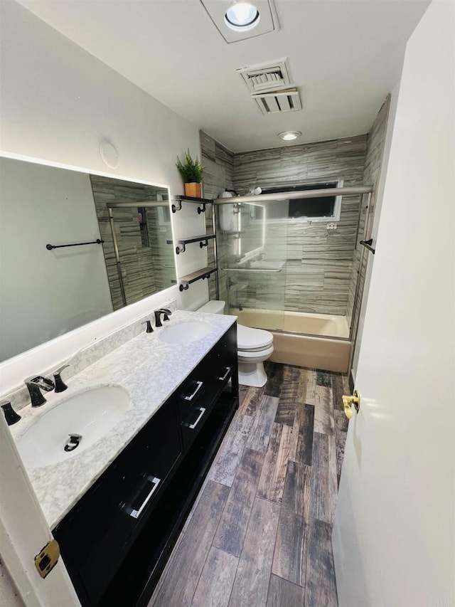 3943 Ingraham St, San Diego, CA 92109 - bathroom featuring double vanity, bath / shower combo with glass door, wood finished floors, and recessed lighting