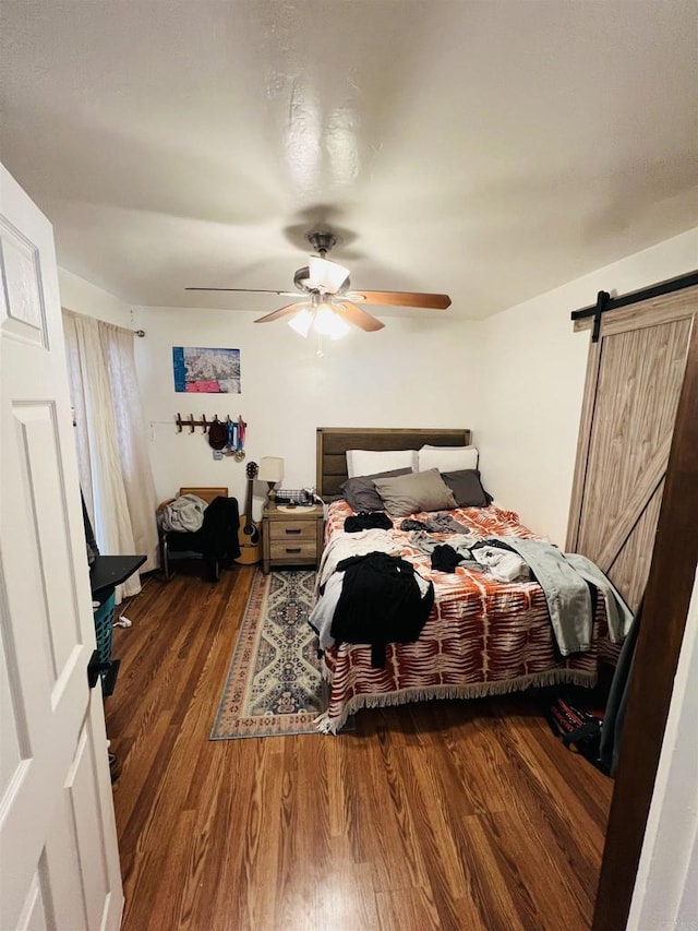 3943 Ingraham St, San Diego, CA 92109 - bedroom featuring wood finished floors, a barn door, and ceiling fan