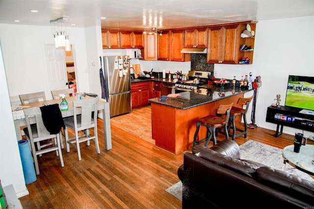 3943 Ingraham St, San Diego, CA 92109 - kitchen featuring stainless steel appliances, a peninsula, under cabinet range hood, wood finished floors, and recessed lighting
