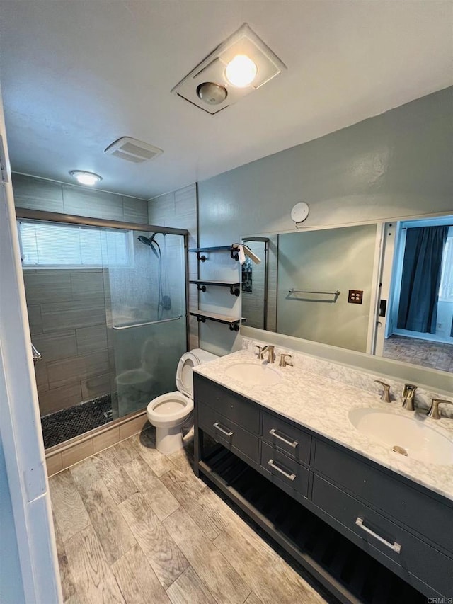 3943 Ingraham St, San Diego, CA 92109 - bathroom featuring a stall shower, double vanity, and wood finished floors