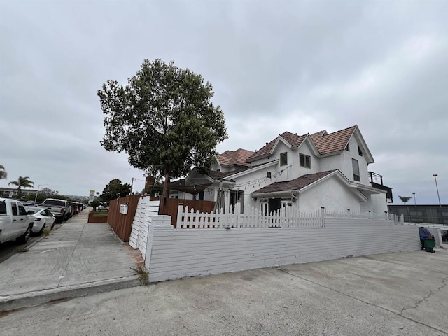 3943 Ingraham St, San Diego, CA 92109 - view of front facade featuring a fenced front yard and stucco siding