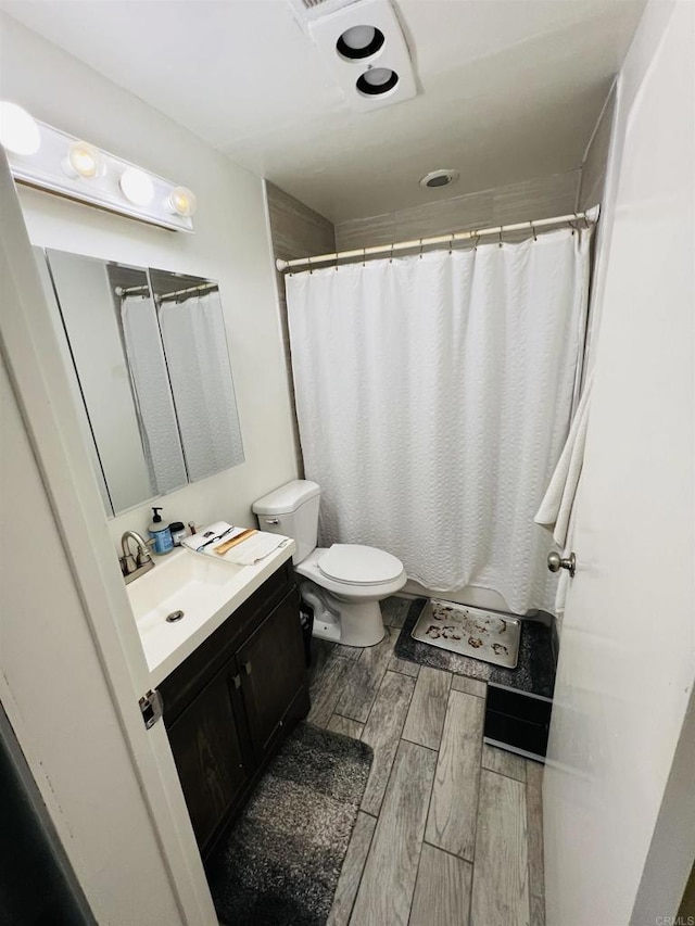3943 Ingraham St, San Diego, CA 92109 - full bath with vanity, wood finished floors, and a shower with shower curtain