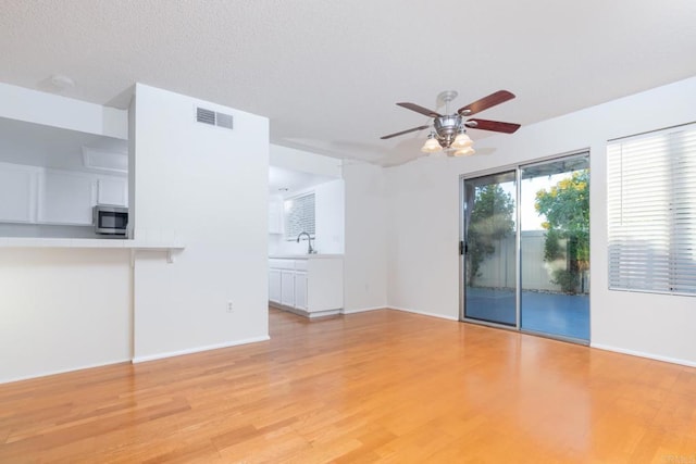 10500 Flora Azalea Ct, Santee, CA 92071 - unfurnished living room featuring a ceiling fan and light wood-style flooring
