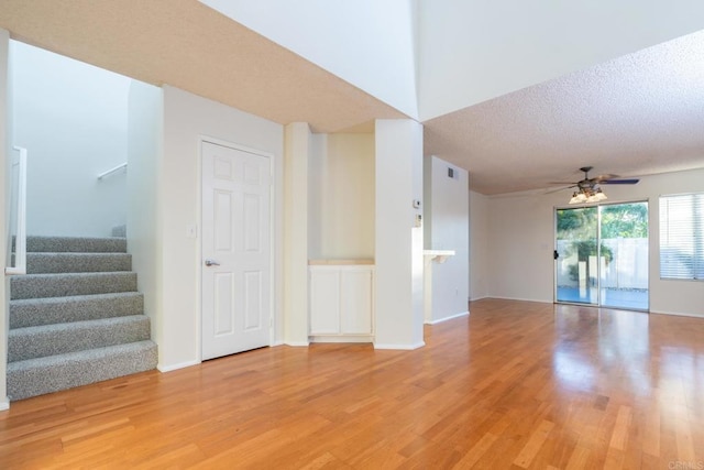 10500 Flora Azalea Ct, Santee, CA 92071 - unfurnished living room featuring light wood-style floors, a ceiling fan, stairway, and a textured ceiling