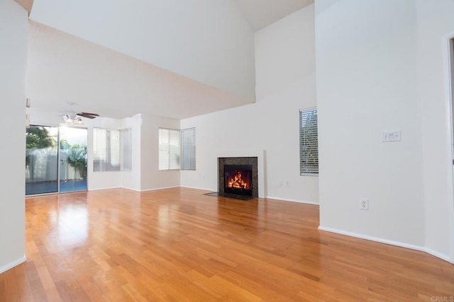 10500 Flora Azalea Ct, Santee, CA 92071 - unfurnished living room featuring high vaulted ceiling, light wood-style flooring, a ceiling fan, and a fireplace with flush hearth
