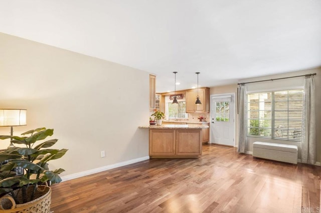 1772 Treseder Cir, El Cajon, CA 92019 - kitchen featuring light wood-style flooring, a peninsula, light stone counters, pendant lighting, and light brown cabinets