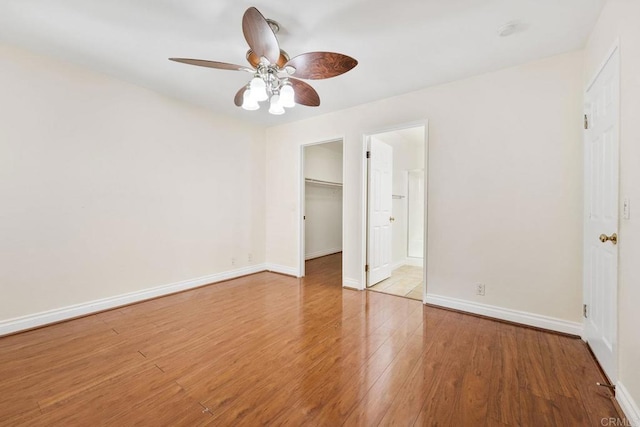 830 Broadway Unit 18, El Cajon, CA 92021 - unfurnished bedroom featuring wood finished floors, a walk in closet, and a ceiling fan