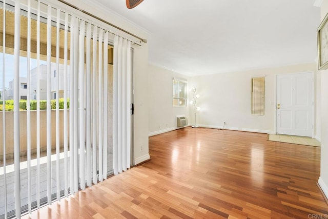 830 Broadway Unit 18, El Cajon, CA 92021 - unfurnished room featuring wood finished floors, ornamental molding, and a wall unit AC
