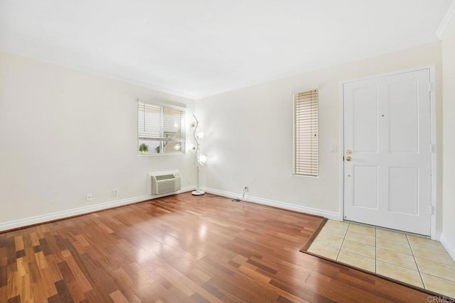 830 Broadway Unit 18, El Cajon, CA 92021 - entrance foyer with wood finished floors, a wall mounted AC, and ornamental molding