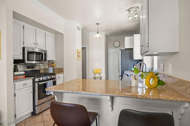 28802 Raintree Ln, Saugus, CA 91390 - kitchen with stainless steel appliances, a peninsula, white cabinets, light stone counters, and crown molding